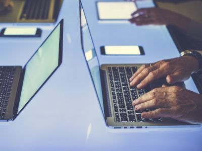 Hand on a laptop working at cyber space table Hand on a laptop working at cyber space table